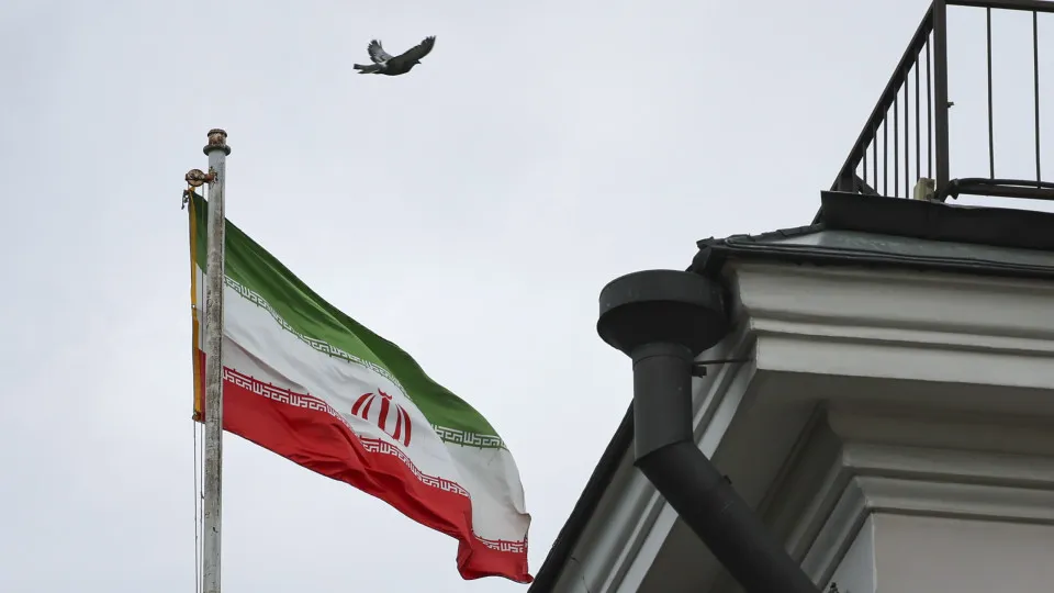 Flowers are left at the Iranian Embassy in Moscow following airstrikes on Iran