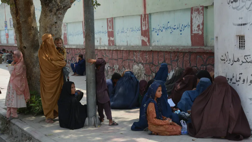 Afghan families, returned from neighboring Pakistan, receive food rations distributed by the Tawheed Charity Foundation in Jalalabad