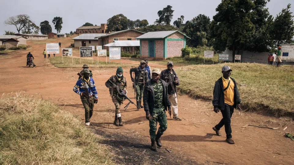 Commanders of the armed group URDPC/CODECO (Union des Révolutionnaires pour la Défense du Peuple Congolais/Coopérative pour le Développement du Congo) walk through the village of Linga on January 13, 2022, in Ituri province, northeastern Democratic Republ