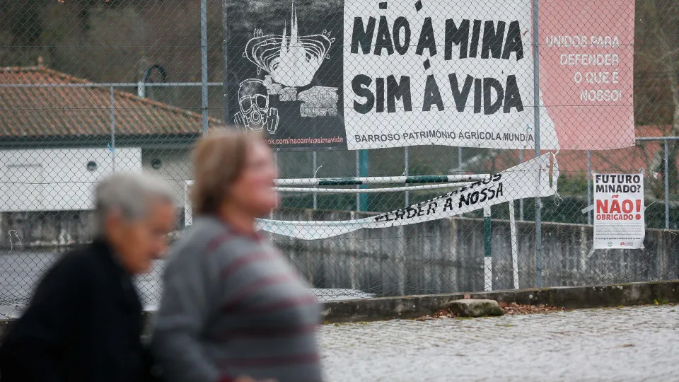 COVAS DO BARROSO, BOTICAS VILA , PORTUGAL - MARCH 10: Two women walk past an anti-mining banner as they go to exercise their right to vote during voting in Portugal's parliamentary elections, at the Junta de Freguesia de Covas do Barroso, March 10, 2024, 
