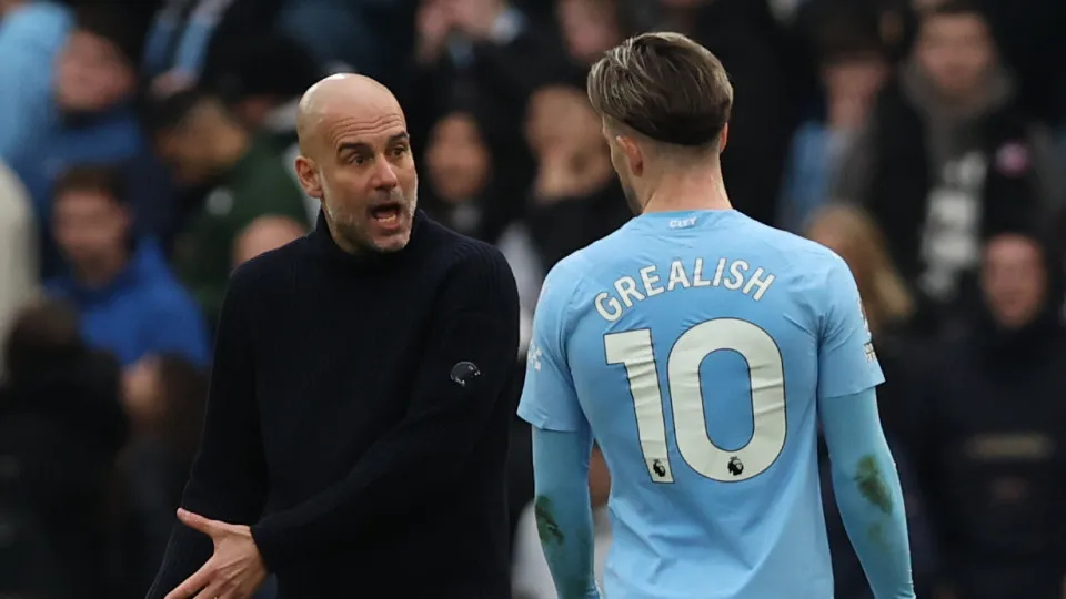 MANCHESTER, ENGLAND - MARCH 31: Manchester City manager Pep Guardiola speaks to Jack Grealish of Manchester City after the Premier League match between Manchester City and Arsenal FC at Etihad Stadium on March 31, 2024 in Manchester, England.(Photo by Dan