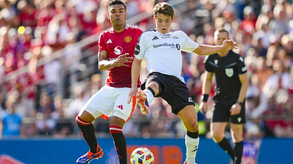 Manchester United's Brazilian midfielder #18 Casemiro (L) and Rosenborg's Norwegian midfielder #41 midfielder Sverre Nypan vie for the ball during the friendly football match between Rosenborg BK and Manchester United at the Lerkendal Stadium in Trondheim