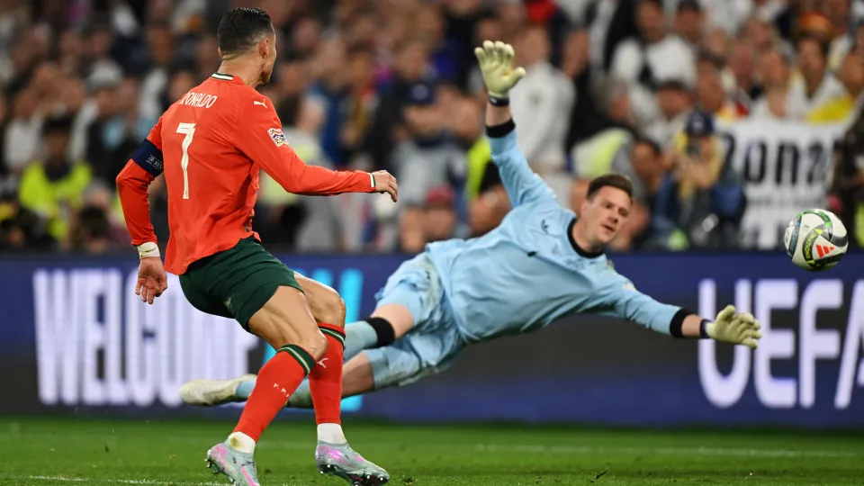 MUNICH, GERMANY - JUNE 04: Cristiano Ronaldo of Portugal scores his team's second goal against Marc-Andre ter Stegen of Germany during the UEFA Nations League 2025 semifinal match between Germany and Portugal at Munich Football Arena on June 04, 2025 in M