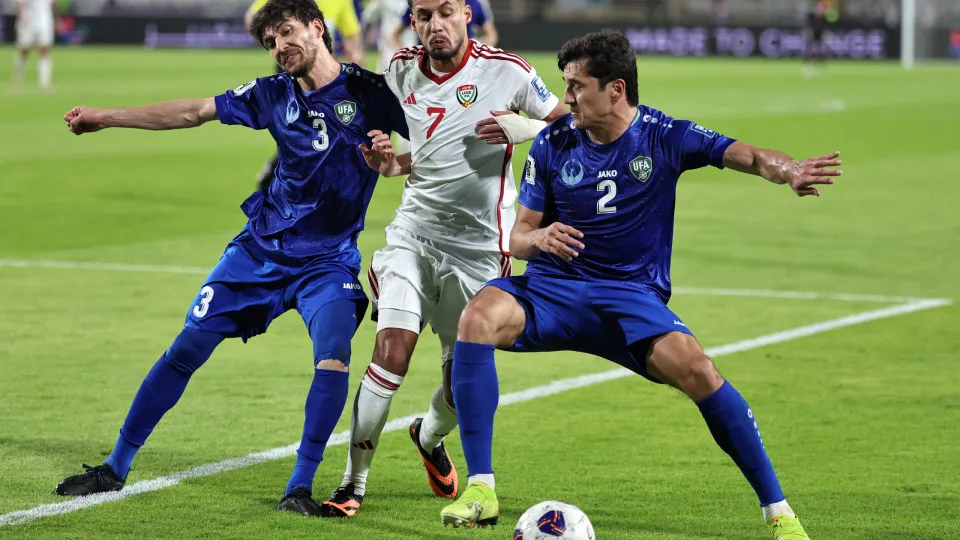 Uzbekistan's defender #3 Khojiakbar Alijonov and defender #2 Abdukodir Khusanov vie for the ball against UAE's forward #7 Ali Saleh during the 2026 FIFA World Cup Asian Qualifier football match between the United Arab Emirates and Uzbekistan at Al-Nahyan 