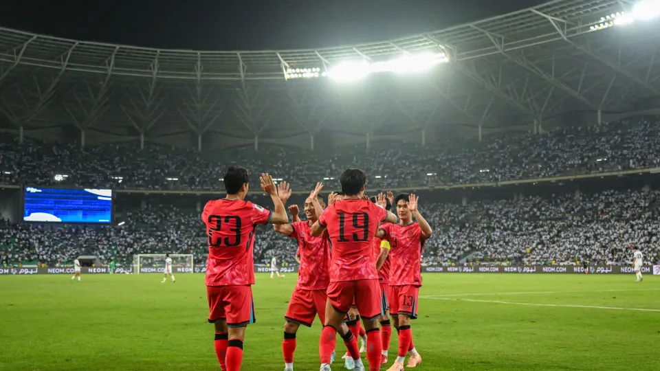 South Korea's forward #19 Oh Hyeon-gyu celebrates with his teammates after scoring his team's second goal during the 2026 FIFA World Cup Asian Qualifier football match between Iraq and South Korea at Basra International Stadium in Basra on June 5, 2025. (