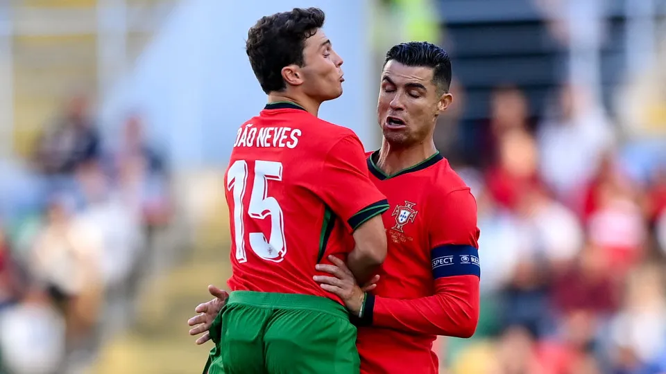 Aveiro , Portugal - 11 June 2024; Cristiano Ronaldo and his Portugal team-mate João Neves collide during the international friendly match between Portugal and Republic of Ireland at Estádio Municipal de Aveiro in Aveiro, Portugal. (Photo By Stephen McCart