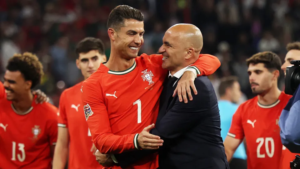 MUNICH, GERMANY - JUNE 08: Cristiano Ronaldo of Portugal celebrates victory with Roberto Martinez, Manager of Portugal, following the UEFA Nations League 2025 final match between Portugal and Spain at Munich Football Arena on June 08, 2025 in Munich, Germ