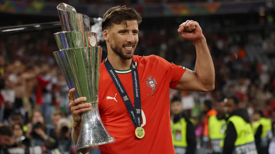 MUNICH,  - JUNE 08: Ruben Dias of Portugal poses for a photograph with the UEFA Nations League trophy after his team's victory in the UEFA Nations League 2025 final match between Portugal and Spain at Munich Football Arena on June 08, 2025 in Munic