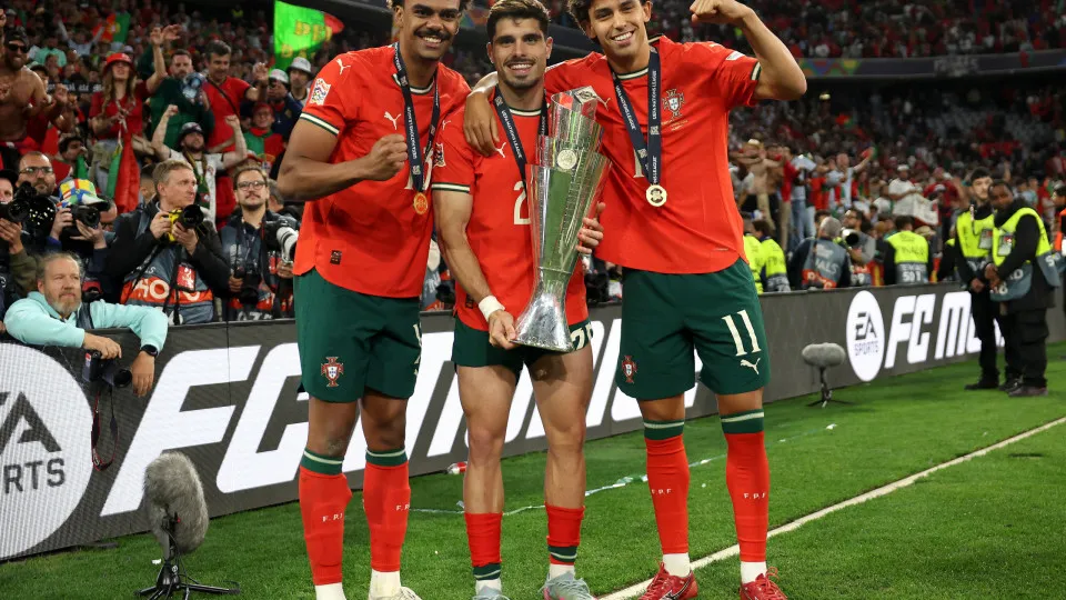 MUNICH, GERMANY - JUNE 08: Vitinha, Pedro Neto and Joao Felix of Portugal pose for a photograph with the UEFA Nations League trophy after their team's victory in the UEFA Nations League 2025 final match between Portugal and Spain at Munich Football Arena 