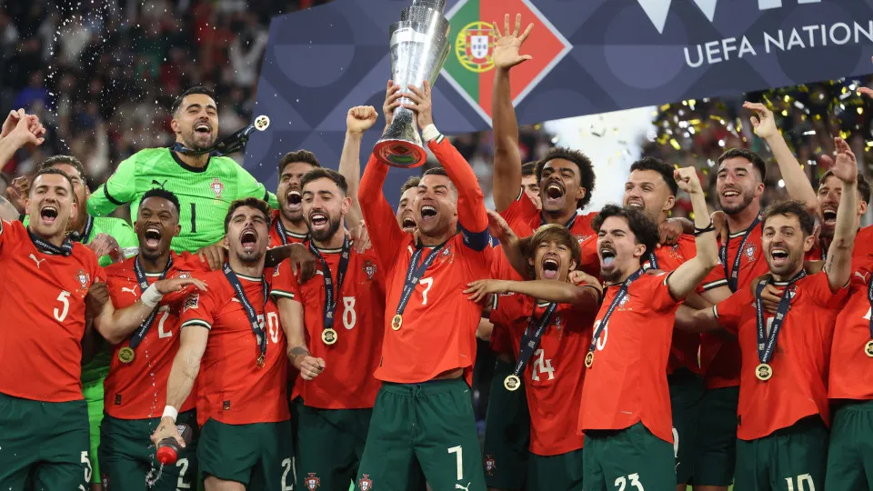 MUNICH, GERMANY - JUNE 8: Cristiano Ronaldo of Portugal Holds aloft the UEFA Nations League Trophy in celebration with his Portugal team mates after winning the Final during the UEFA Nations League 2025 final match between Portugal and Spain at Munich Foo