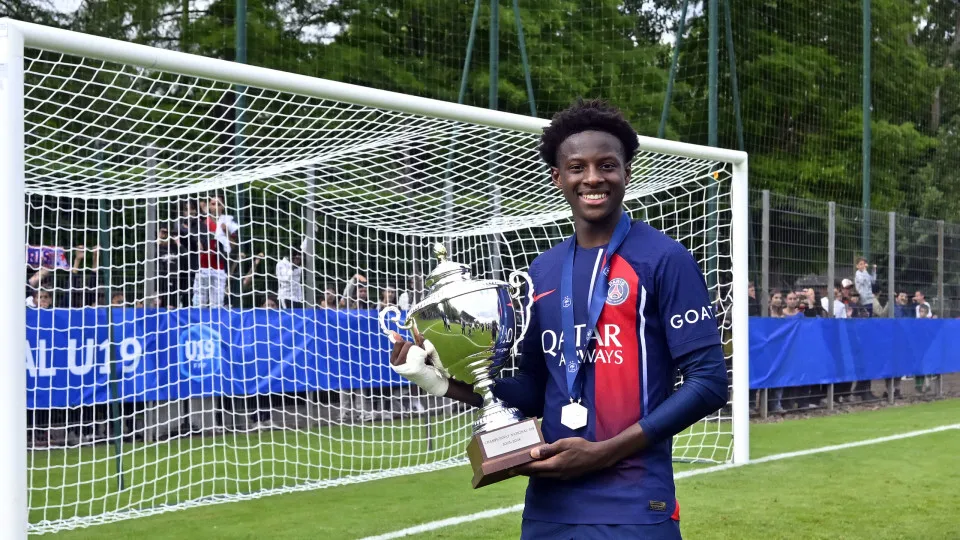 BRIVE-LA-GAILLARDE, FRANCE - JUNE 16: Oumar Camara of Paris Saint-Germain poses with the trophy after winning the U19 Championship final between Paris Saint-Germain U19 and AJ Auxerre U19 on June 16, 2024 in Brive-la-Gaillarde, France. (Photo by Aurelien 