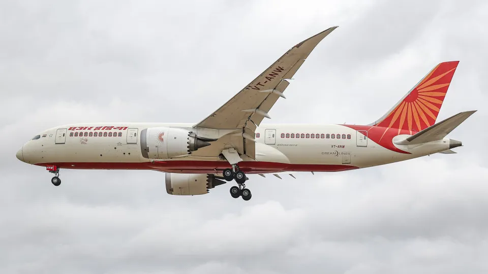 Air India Boeing 787 Dreamliner aircraft as seen on final approach flying for landing at London Heathrow airport during a cloudy day over Myrtle Avenue, a famous planespotting location. The modern and advanced Boeing 787-8 wide body passenger plane has th
