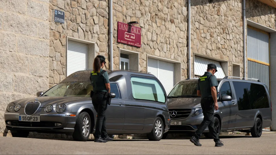 Two civil guards walk past two Portuguese hearses parked outside the funeral home in the Spanish town of Puebla de Sanabria, northwestern Spain, where the bodies of Liverpool's Portuguese forward Diogo Jota and his brother Andre Felipe were taken followin