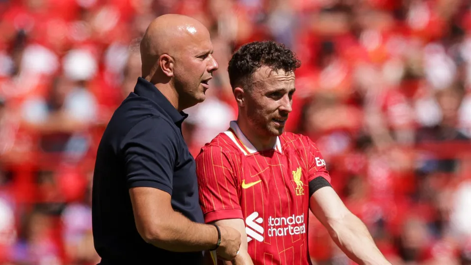 LIVERPOOL, ENGLAND - AUGUST 11: Liverpool manager Arne Slot talks to Liverpool's Diogo Jota during the Pre-Season Friendly between Liverpool and Sevilla, at Anfield on August 11, 2024 in Liverpool, England. (Photo by Barrington Coombs/Getty Images)