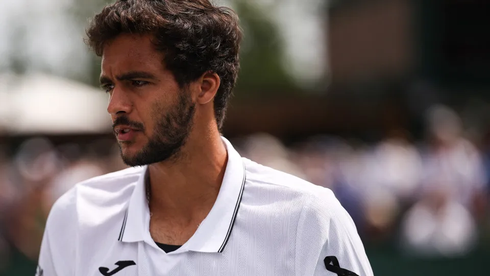 Portugal's Francisco Cabral wears a black ribbon on his sleeves as a tribute to late Liverpool and Portugal forward Diogo Jota during his men's doubles second round tennis match on the fifth day of the 2025 Wimbledon Championships at The All England Lawn 