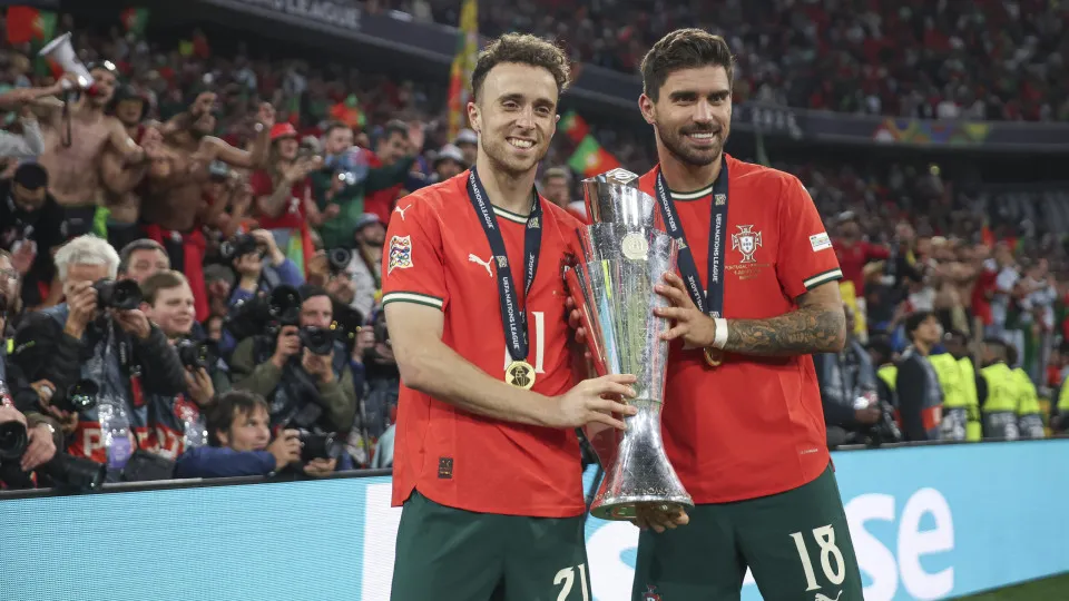 MUNICH, GERMANY - JUNE 08: Diogo Jota of Portugal and Ruben Neves pose for a photograph with the UEFA Nations League trophy after his team's victory in the UEFA Nations League 2025 final match between Portugal and Spain at Munich Football Arena on June 08