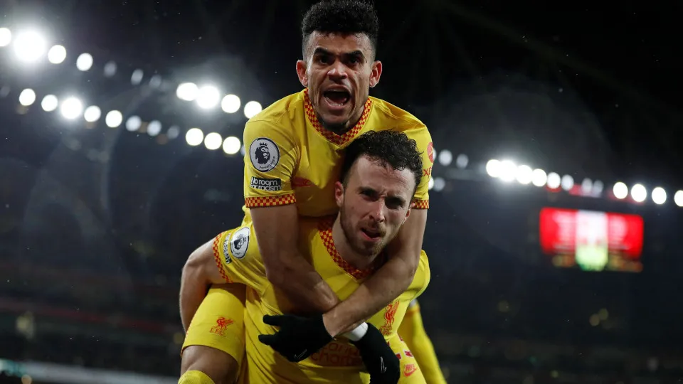 Liverpool's Portuguese striker Diogo Jota celebrates scoring the opening goal with Liverpool's Colombian midfielder Luis Diaz during the English Premier League football match between Arsenal and Liverpool at the Emirates Stadium in London on March 16, 202