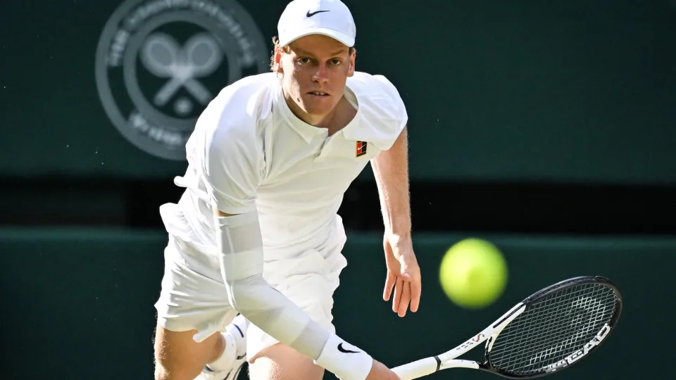 Italy's Jannik Sinner eyes the ball as he plays against Spain's Carlos Alcaraz during their men's singles final tennis match on the fourteenth day of the 2025 Wimbledon Championships at The All England Lawn Tennis and Croquet Club in Wimbledon, southwest 