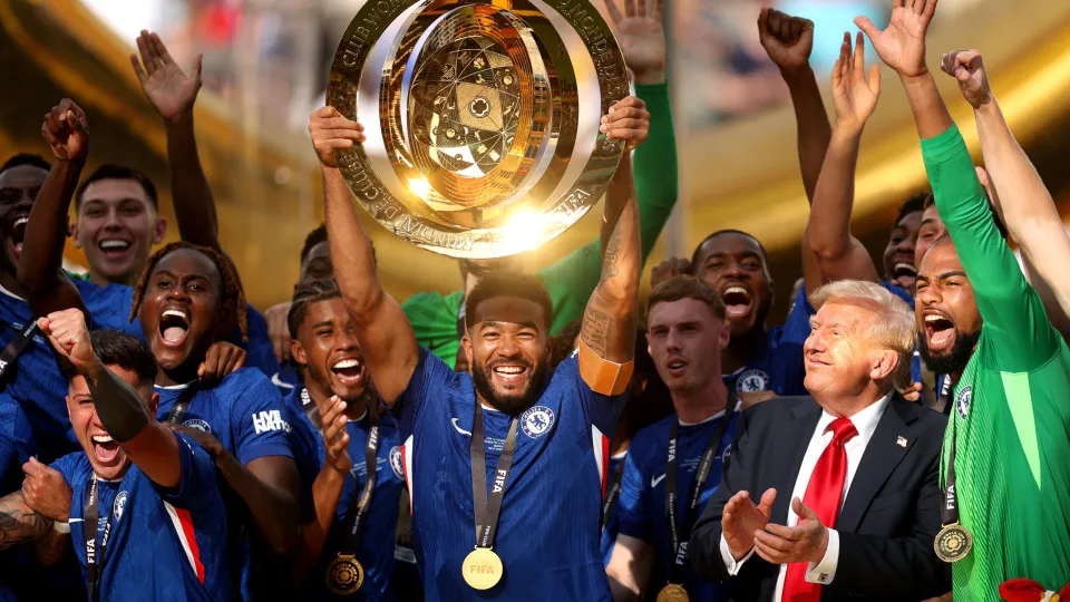 EAST RUTHERFORD, NEW JERSEY - JULY 13: Reece James #24 of Chelsea FC lifts the FIFA Club World Cup trophy after their team's victory as U.S. President Donald Trump reacts following the FIFA Club World Cup 2025 Final match between Chelsea FC and Paris Sain