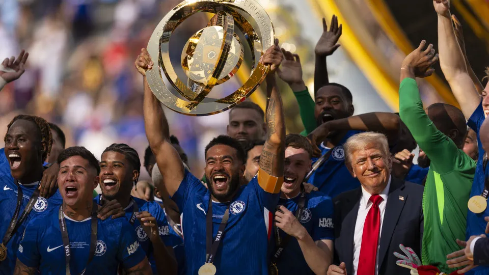 EAST RUTHERFORD, NEW JERSEY - JULY 13: Reece James #24 of Chelsea FC lifts the FIFA Club World Cup trophy after their team's victory as U.S. President Donald Trump reacts following the FIFA Club World Cup 2025 Final match between Chelsea FC and Paris Sain