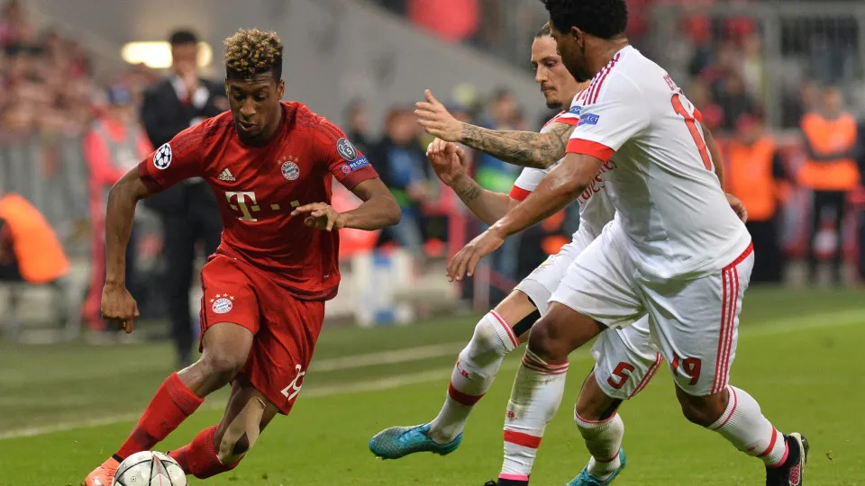 MUNICH, GERMANY - April 5: Kingsley Coman (L) of Munich and Ljubomir Fejsa (C) and Eliseu (R) of Lisbon vie for the ball during the Champions League quarter final soccer match between FC Bayern Munich and Benfica Lisbon at the Allianz Arena on April 5, 20