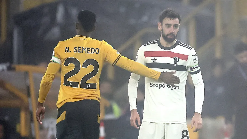 Wolverhampton Wanderers' Portuguese defender #22 Nelson Semedo consoles Manchester United's Portuguese midfielder #08 Bruno Fernandes after being shown a red card during the English Premier League football match between Wolverhampton Wanderers and Manches