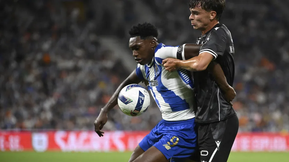 FC Porto's Spanish forward #09 Samuel Omorodion (L) and Vitoria Guimaraes' Portuguese defender #03 Miguel Nobrega fight for the ball during the Portuguese League football match between FC Porto and Vitoria Guimaraes SC at Dragao stadium in Porto on August