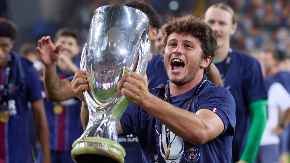 UDINE, ITALY - AUGUST 13: Joao Neves of Paris Saint-Germain celebrates winning the UEFA Super Cup 2025 against Tottenham Hotspur with the UEFA Super Cup Trophy during the UEFA Super Cup 2025 match between Paris Saint-Germain and Tottenham Hotspur at Friul