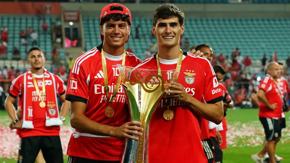 FARO, PORTUGAL - JULY 31: Antonio Silva of SL Benfica (R) and Rafael Luis of SL Benfica (L) pose for a picture with trophy after winning the Portuguese Super Cup at the end of the Portuguese Super Cup match between Sporting CP and SL Benfica at Estadio Al