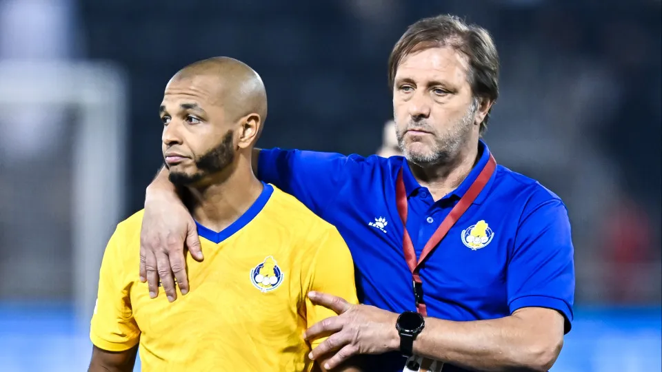 Vacine Brahimi (L) and Pedro Rui Martins, head coach of Al Gharafa SC, walk off the field after losing the Qatar Cup Semi-final match between Al-Gharafa SC and Al-Duhail SC at Jassim Bin Hamad Stadium in Doha, Qatar, on April 23, 2025. (Photo by Noushad T